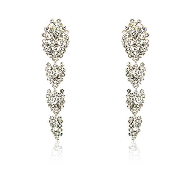 istock Pair of silver diamond earrings isolated on white 619229518