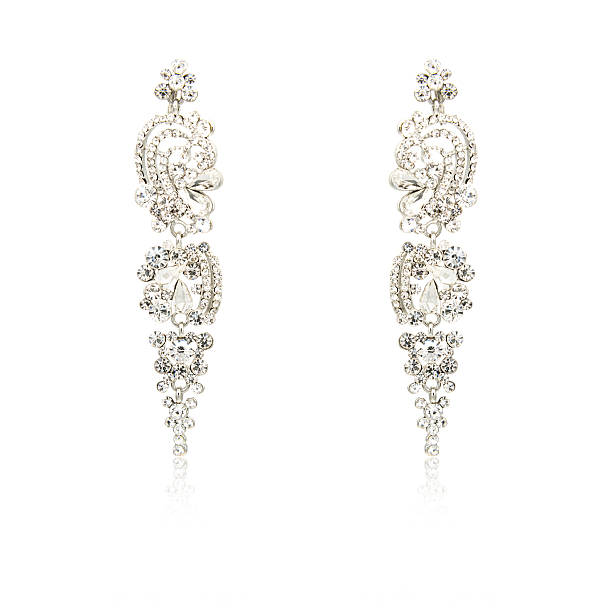 istock Pair of silver diamond earrings isolated on white 619229578