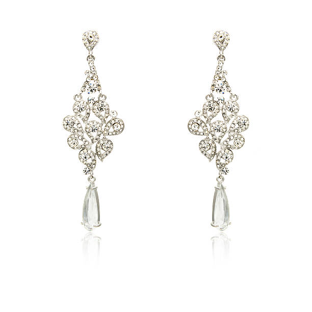 istock Pair of silver diamond earrings isolated on white 619229672