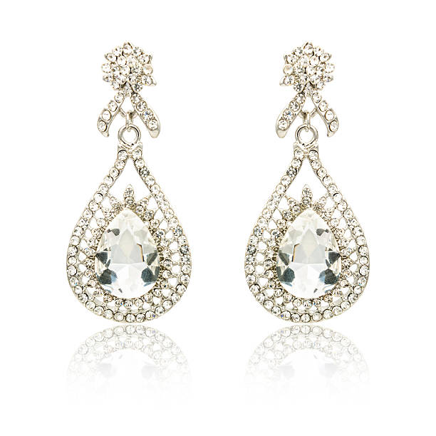 istock Pair of silver diamond earrings isolated on white 619229706