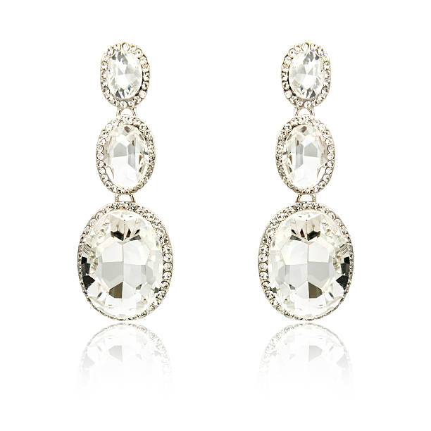 istock Pair of silver diamond earrings isolated on white 619229740