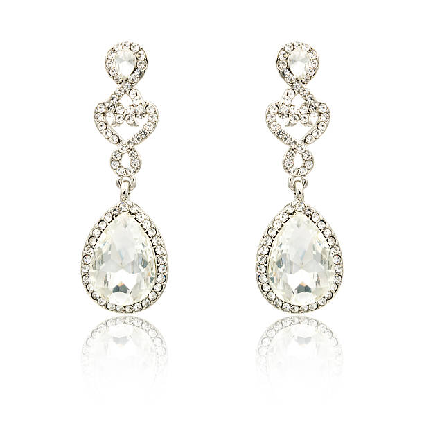 istock Pair of silver diamond earrings isolated on white 619229866