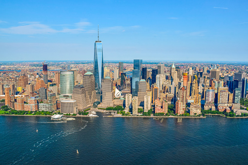 Shot from a helicopter, a view of beautiful Manhattan, New York on a clear blue sky summer day. New York City is a large American City in the State of New York.