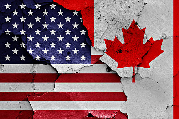 istock flags of USA and Canada painted on cracked wall 619230648
