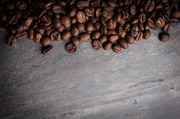 istock Coffee beans on grunge stone background 619230894