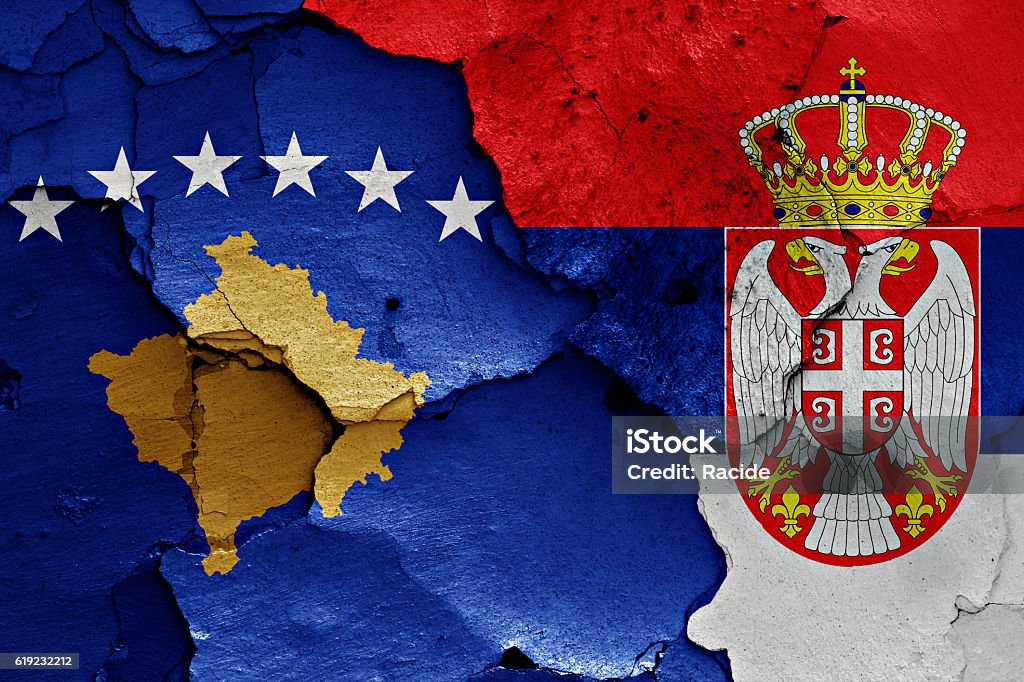 flags of Kosovo and Serbia painted on cracked wall Kosovo Stock Photo