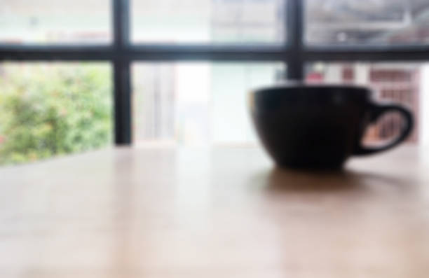 istock Hot cup of coffee on wooden table 619232822