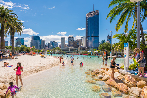 Brisbane, Australia - September 25, 2016: View of people swimming at the Streets Beach, inner-city and man-made beach, with skyscrapers in the background in South Bank, Brisbane.