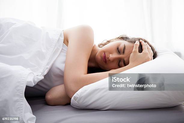 Young Beautiful Caucasian Woman On Bed Having Headache Stock Photo - Download Image Now