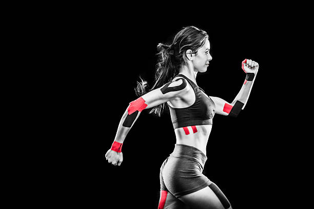 istock Women Runner With Kinesiology Tape On Her Joints 619243602