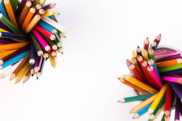 Color pencils in two office bins in different corners stock photo