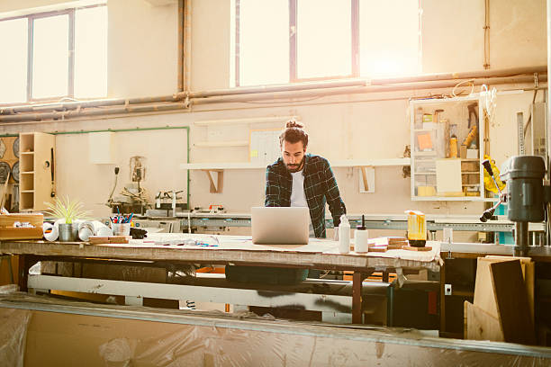 istock Male Carpenter Standing In His Workshop 619244870