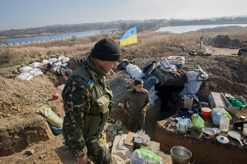 Luhanskoe, Ukraine - November 6, 2014: Ukrainian servicemen during the rotation at a checkpoint near the village of Luganskoe, in the Donetsk region.