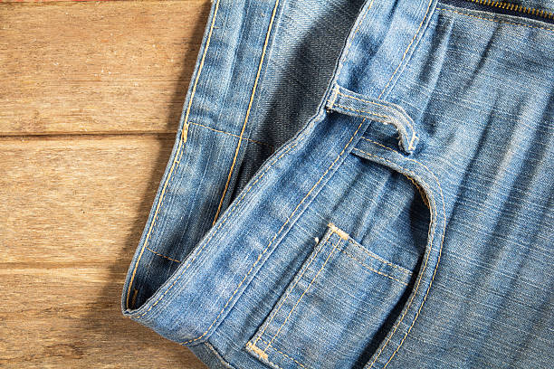 istock jeans stacked on a wooden background 619251222