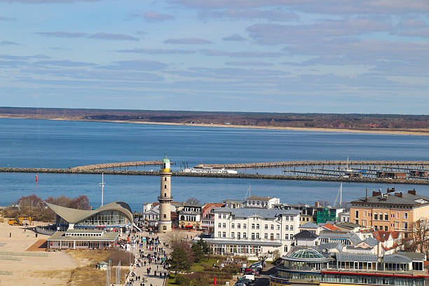 istock harbor entrance from Warnemuende Germany with lighthouse 619252058