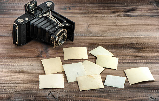 istock Vintage photo camera and old paper photos 619252536