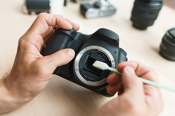 istock Close-up of camera matrix cleaning, technician pov 619252590