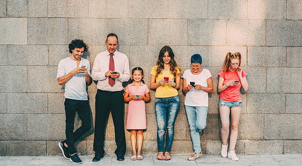 Texting at different ages Six people at different ages texting seperately. different families stock pictures, royalty-free photos & images