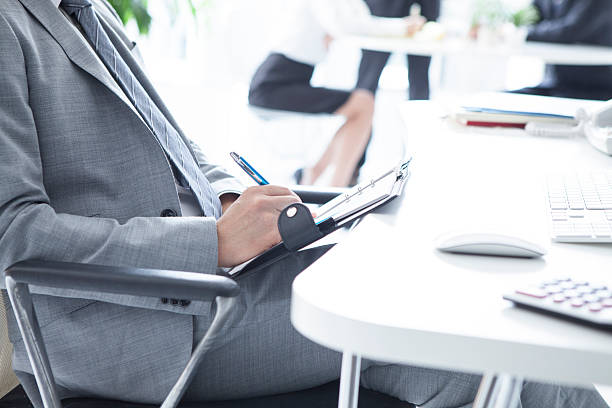 istock Businessman with a note in a notebook in the office 619255342