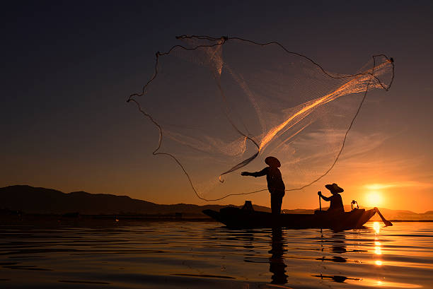 istock Fisherman Thailand on the river and sunrise . 619255634