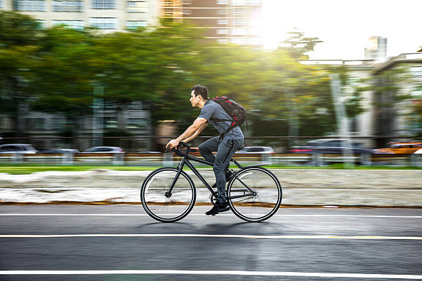 Young man cycling in the city, commuting to work