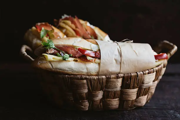 Photo of Sandwiches in the wooden  basket