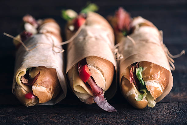 tre panini sumbmarine - sandwich delicatessen bread gourmet foto e immagini stock