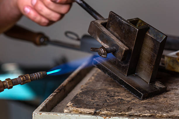 istock Blowtorch on Metal Mold at Goldsmith Workshop 619257604