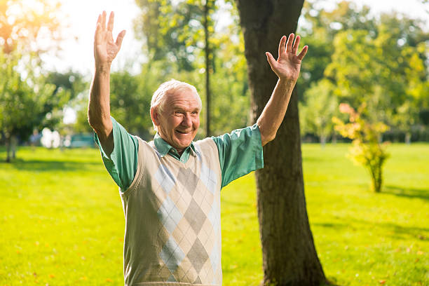 istock Senior male with raised arms. 619258974