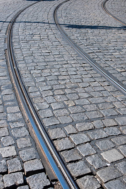 istock Tram way on old cobblestone street 619260174