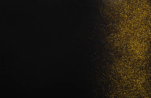 istock Golden glitter sand texture border on black, abstract background. 619260354
