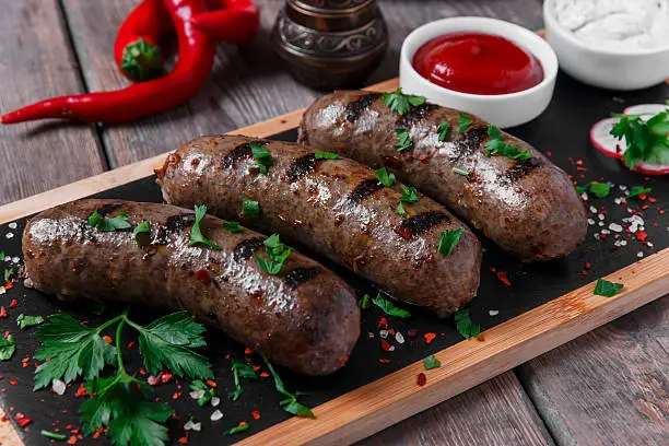 Photo of homemade cooked sausages fried on a grill beef