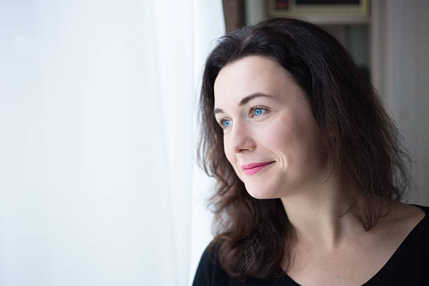 istock Woman looks out the window. 619263208