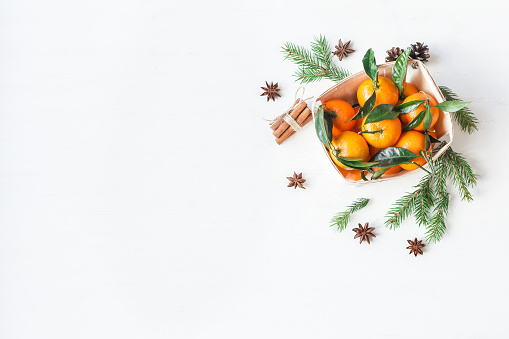 Christmas composition with tangerines, fir branches, cinnamon sticks, anise star. Christmas background. Flat lay, top view