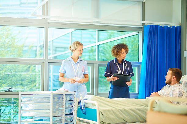 istock senior nurse chatting to patient 619265224