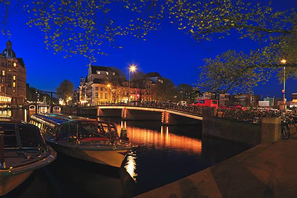 istock Canal Boat and Bridge at night, Amsterdam, Netherlands 619265582