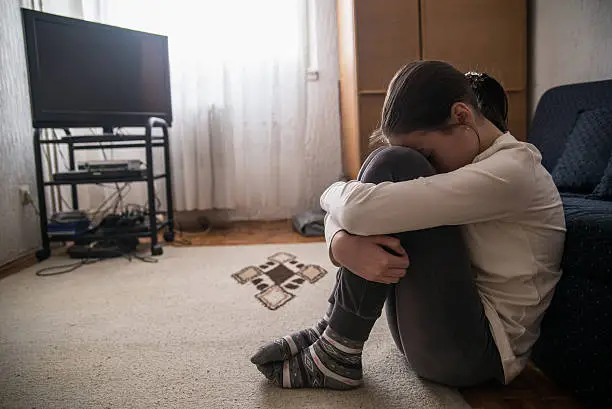 Photo of Teen woman with headache holding her head