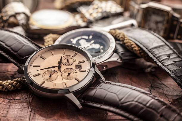 istock men watches on wooden table 619267198