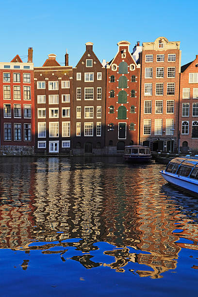 istock Typical Dutch houses built by the canal, Amsterdam, Netherlands 619267278