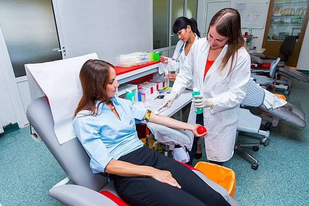 Young woman is going to donate blood in  blood bank Young woman is going to donate blood in a blood bank,young woman doctor making prepairs,other from Phillippines behind blood bank stock pictures, royalty-free photos & images