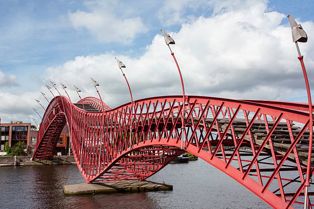 istock Red sinuous pedestrian bridge in Amsterdam over the river 619267548