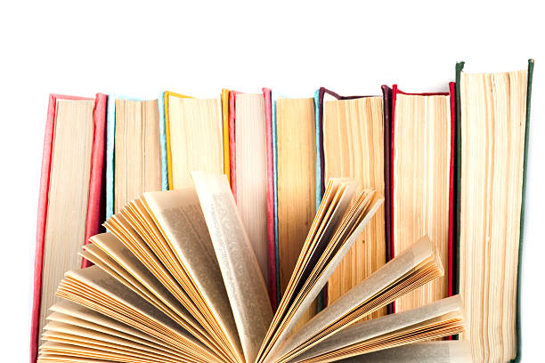 istock Open book, stack of colorful hardback books on light table. 619269172