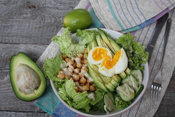 istock healthy salad in a bowl. avocado, chickpeas, cucumber and egg. 619270158