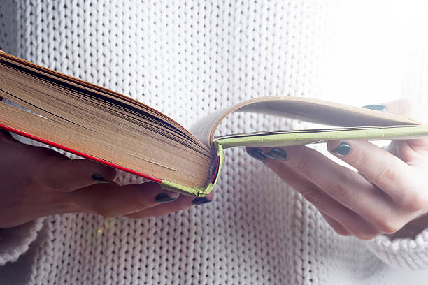 istock Young girl reading an open old book. Knowledge, 619270216