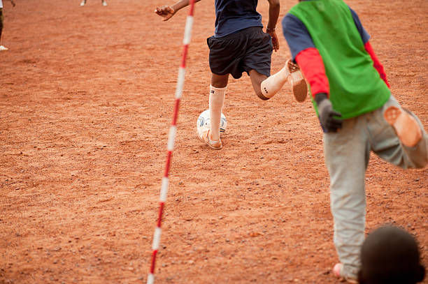 neri che giocano a calcio in un villaggio rurale - africa south africa child african culture foto e immagini stock