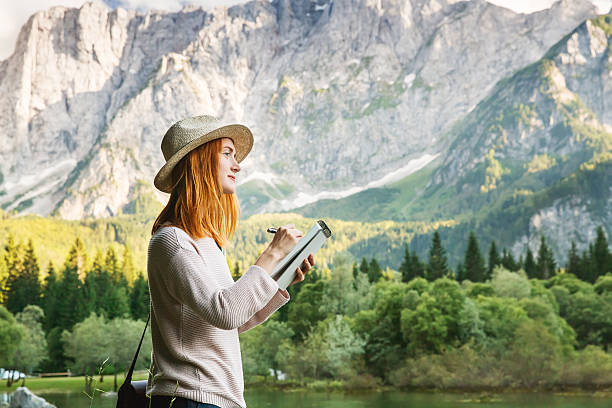istock Young woman making sketches on the nature 619270792