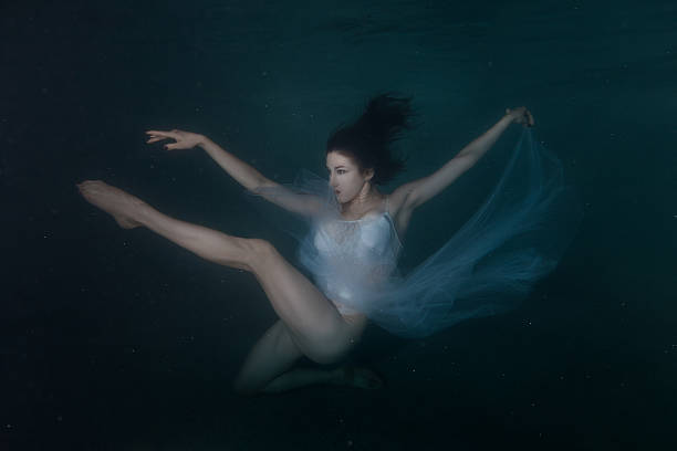 istock Woman dancing in the water. 619272498