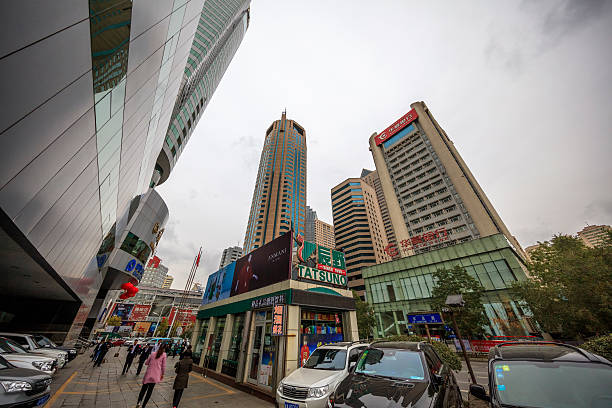 Urumqi, Xinjiang, China- October 13, 2016: Urumqi downtown street view. Bus and Taxi on the road, business buildings on the road sides, incidental people on the background.