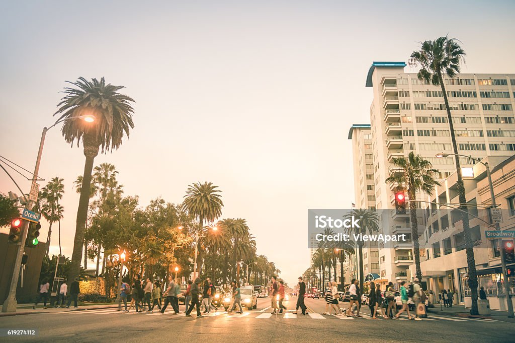 Locals and tourists walking on Ocean Ave in Santa Monica Locals and tourists walking on zebra crossing in Ocean Ave in Santa Monica after sunset - Crowded streets of Los Angeles and California state - People are slightlu blurred to make them unrecognizable Santa Monica Stock Photo