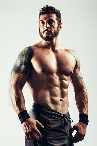 Studio shot of male with perfect muscle built.